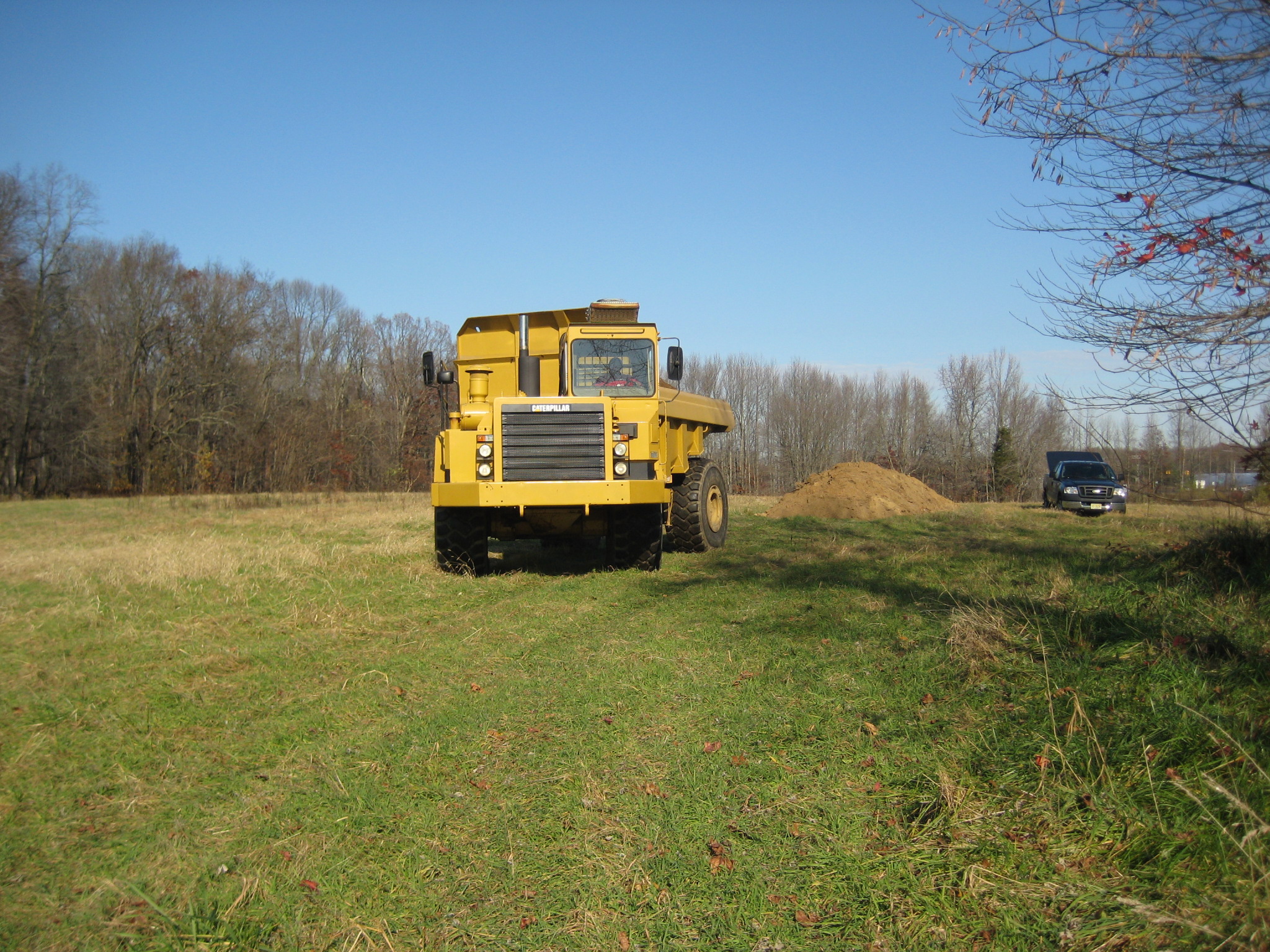 Field truck moving contaminated soil - Farm dump cleanup