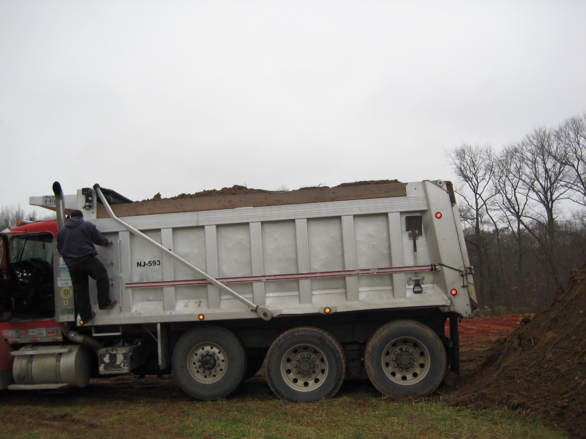 Excavator loading truck - Farm Dump Cleanup & Soil Replacement