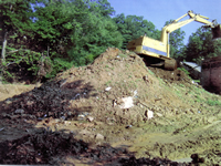 Loading dirt into screening machine - Farm dump cleanup