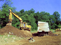Loading dirt into screening machine - Farm dump cleanup
